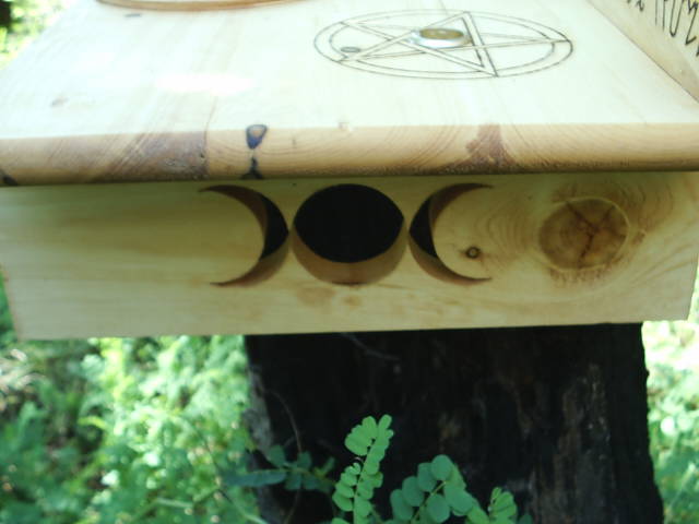 Goddess symbol scrolled into the facing right leg of the wiccan altar