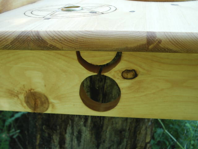 God symbol scrolled into the facing left leg of the wiccan altar.